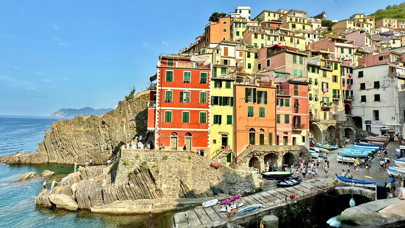Vibrant coastal village with colorful buildings in Riomaggiore, Cinque Terre, Italy.